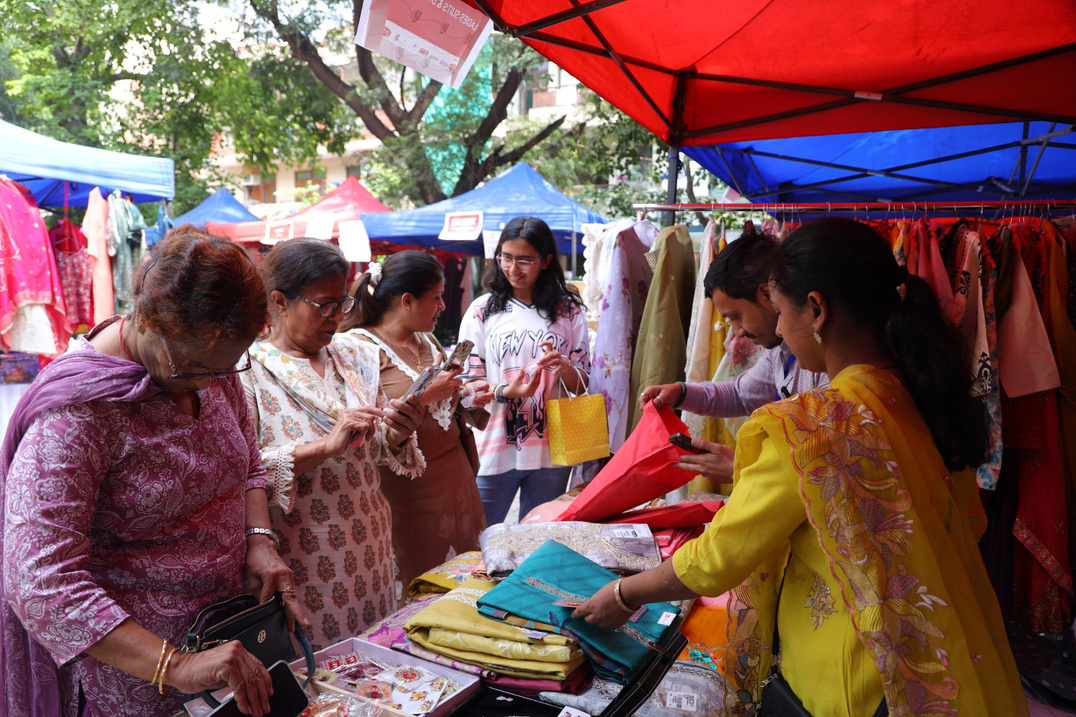 Women shopping at a festive clothing stall at Wonder Women Utsav